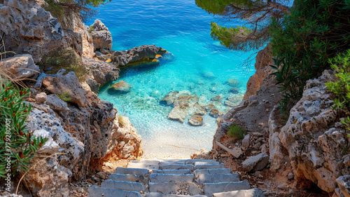 A sandy pathway leading to a hidden cove with crystal-clear waters.