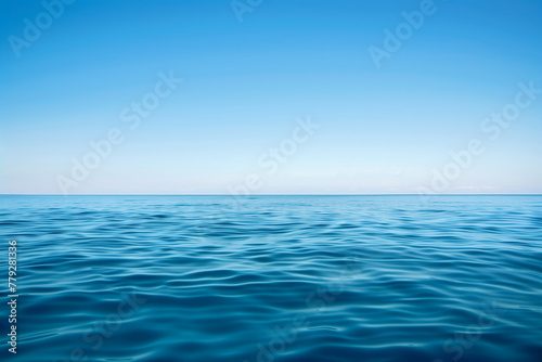 Calm sea with endless ocean and its horizon separating the sky from the blue waterand copy space