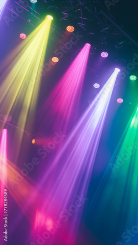 Vivid colored stage lights piercing through haze at a live event, creating a dynamic atmosphere. © Ritthichai