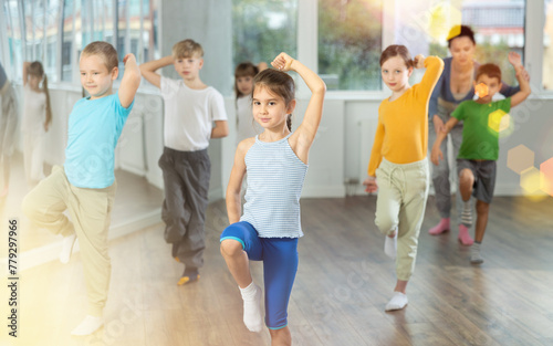 Group of boys and girls rehearsing hip hop dance in studio