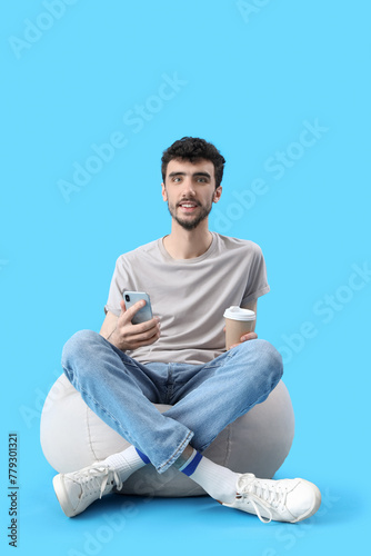 Handsome young man with cup...