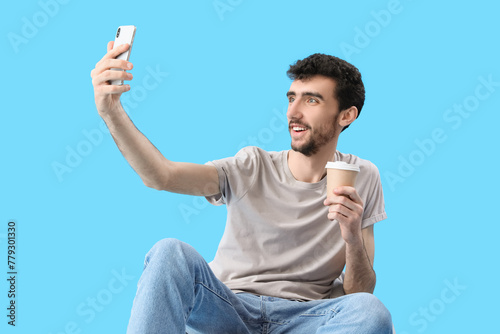 Handsome young man with cup...
