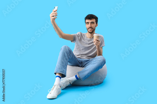 Handsome young man with cup...