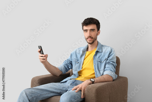 Handsome young man using mo...
