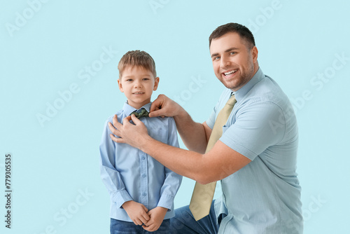 Happy father helping son ad...