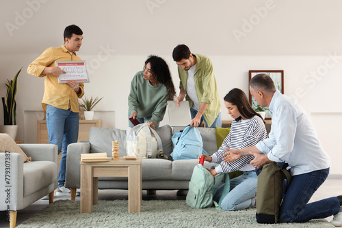 Fotografía People with evacuation plan packing things indoors