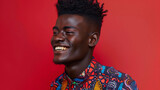 A closeup shot of a black man with a bold multicolored patterned shirt and a sleek highcontrast hairstyle. His face is lit up in a playful smile reflecting the joy and energy that .