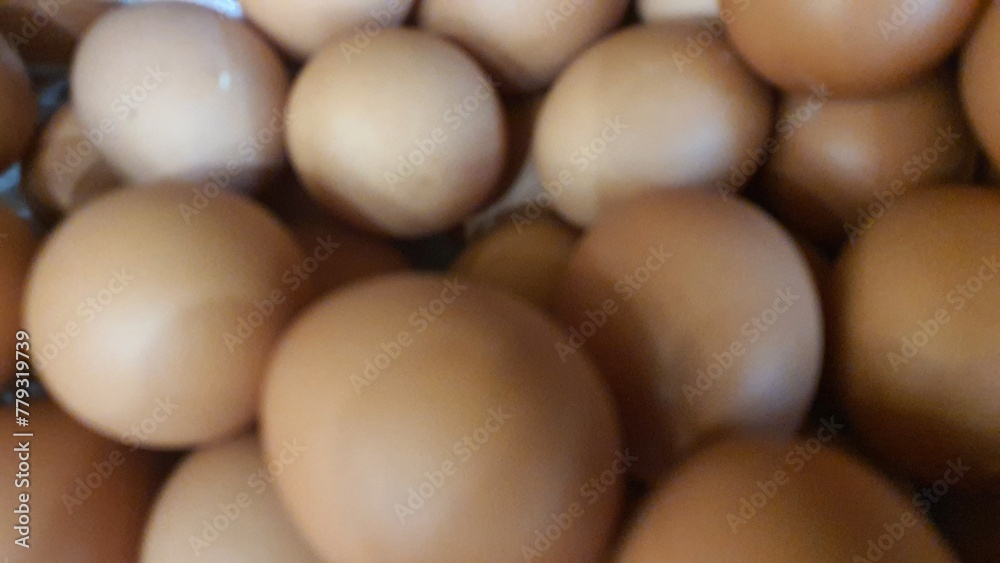 Close up of randomly stacked chicken eggs sold at the market as a background.
Close up of randomly stacked chicken eggs sold at the market as a background.