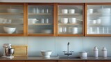 A kitchen with a midcentury modern design features frosted glass cabinet doors adding a subtle touch of elegance and privacy to the space. The frosted glass doors also create a beautiful .