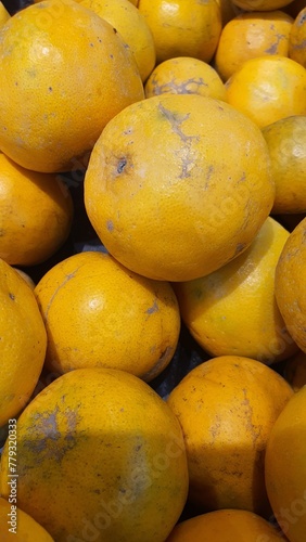 Close up pile of tasty fresh oranges sold at the market as a background.	
