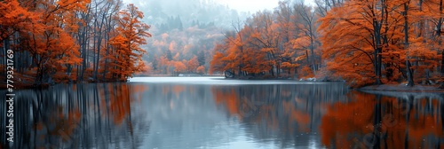 A serene lake surrounded by autumn trees with leaves in shades of orange  red  and yellow. 