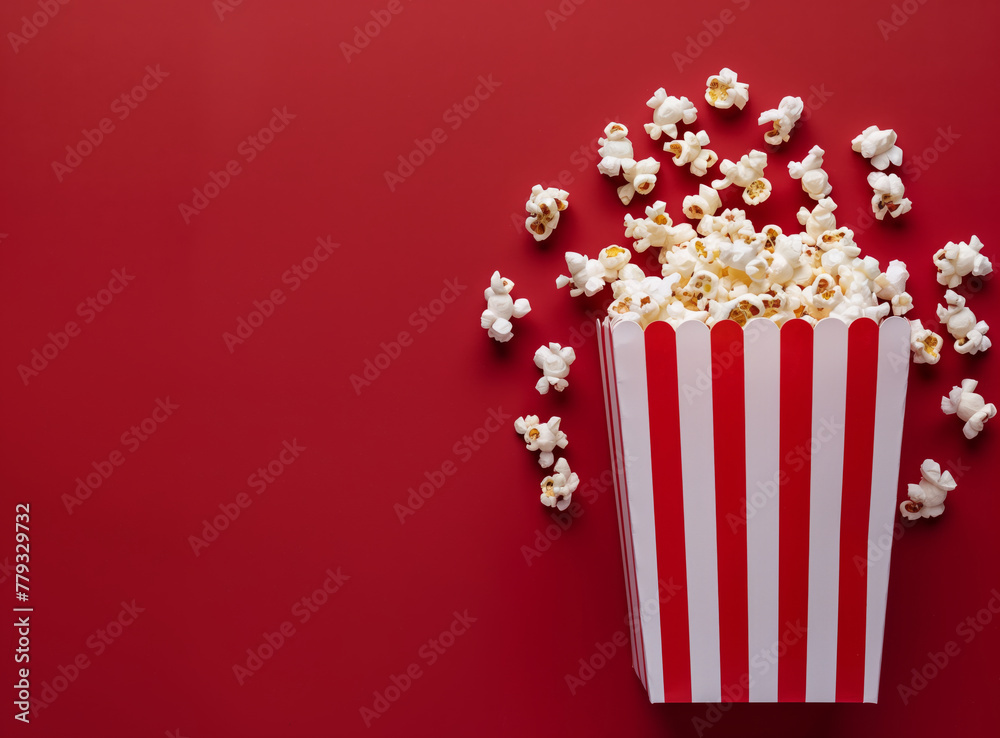 Top view of a bucket full of popcorn on a red copy space