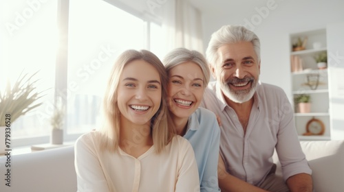 Family portrait, three generations, happy smiles, home setting.