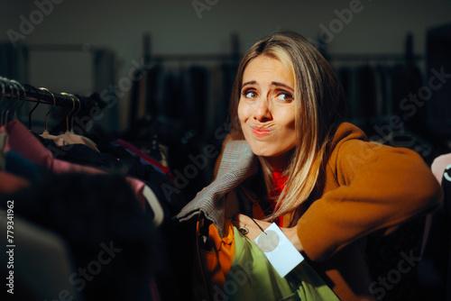 Shoplifter Trying to Hide Stolen Clothing Items in a Bag. Criminal behavior in a fashion store customer ready to steal 
