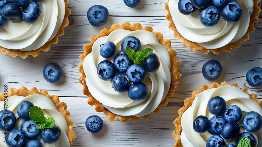Tartlets with blueberries on a white wooden background, top view - obrazy, fototapety, plakaty 