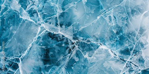 A close-up view of an icy surface reveals delicate cracks and the texture of frozen water in shades of blue and white. photo