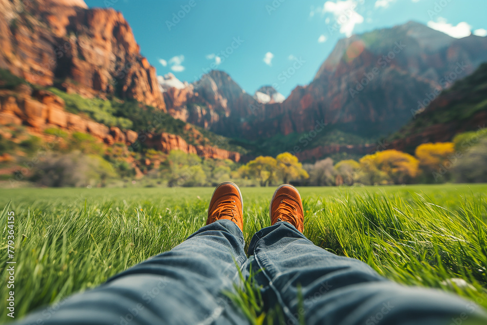 Person lying in grass with view of mountains in the distance. Travel and adventure concept. Perfect for promoting outdoor gear, nature tourismwith space for text, generative ai Person lying in grass with view of mountains in the distance. Travel and adventure concept. Perfect for promoting outdoor gear, nature tourismwith space for text, generative ai
