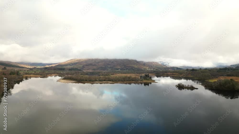 Upward Linear Drone View of Majestic Mountain Lake Surrounded by Peaks with Abandoned Castle Upward Linear Drone View of Majestic Mountain Lake Surrounded by Peaks with Abandoned Castle