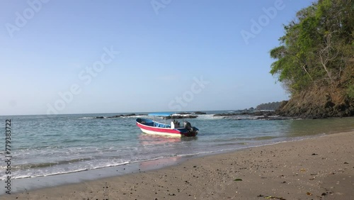 Static shot of a boat floating in the current at Cebaco Island Veraguas photo