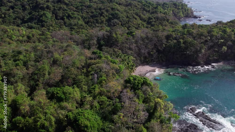 Aerial establishing shot of a remote beach with a boat at Cebaco Island Aerial establishing shot of a remote beach with a boat at Cebaco Island
