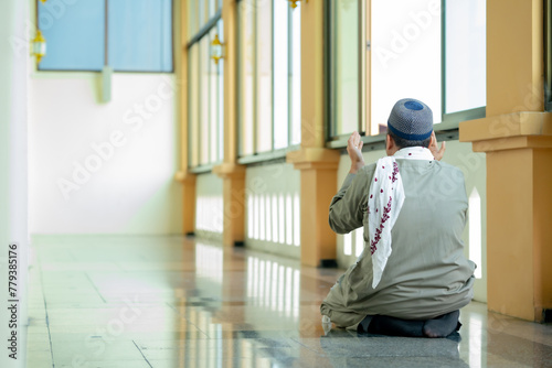 Ramadan, Muslim, Isalam, An Asian Muslim man is praying with peace in the beautiful mosque, giving a powerful atmosphere of faith, with copy space, Islam concept.