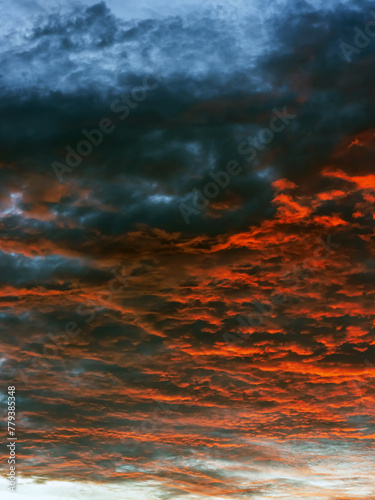 Beautiful view of sunset sky after sun has gone below the horizon. Only the sky above the horizon. Cirrus low clouds. Dramatic sunset. Fantastic dark blue thunderclouds at sunset, Natural composition.