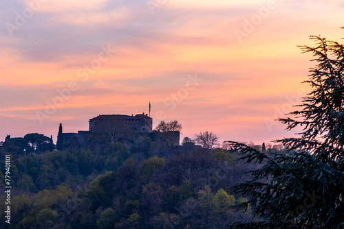 Gorizia Castle seen from the top of the hill over Nova-Gorica in Slovenia. Quiet day, relaxing places in the greenery, panorama with sunset and warm-colored clouds. Cultural Heritage Capital 2025.