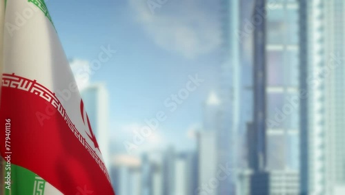 hanging Iran flag on city background with blue sky