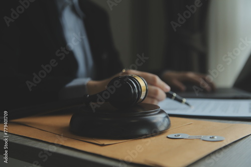 Business and lawyers discussing contract papers with brass scale on desk in office. Law, legal services, advice, justice and law concept picture with film grain effect