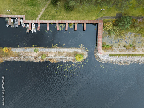 Aerial drone top view of boats standing near the pier in the river © gannusya