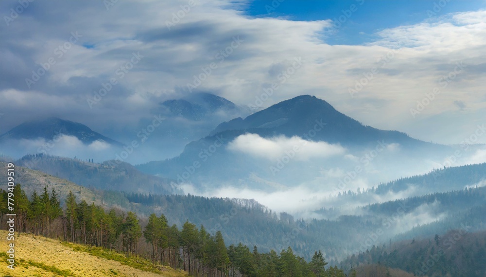 Foggy mountains, with trees, forest and a blue sky