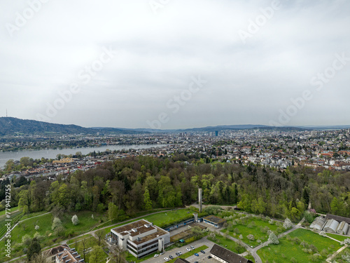 Aerial view over Swiss City of Zürich with woodland and Lake Zürich with local mountain Uetliberg in the background on a cloudy spring day. Photo taken April 7th, 2024, Zurich, Switzerland. photo