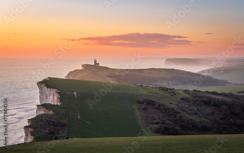 Beautiful sunset and scenery from the cliff edge of Beachy  Head with Belle Tout lighthouse on the east Sussex coast south east England UK photo