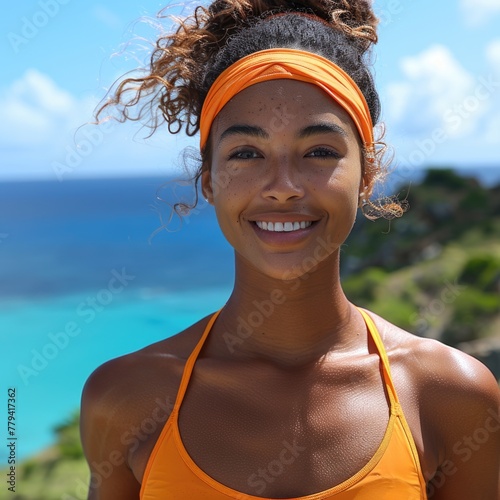 Smiling young woman outdoors with blue sky background.