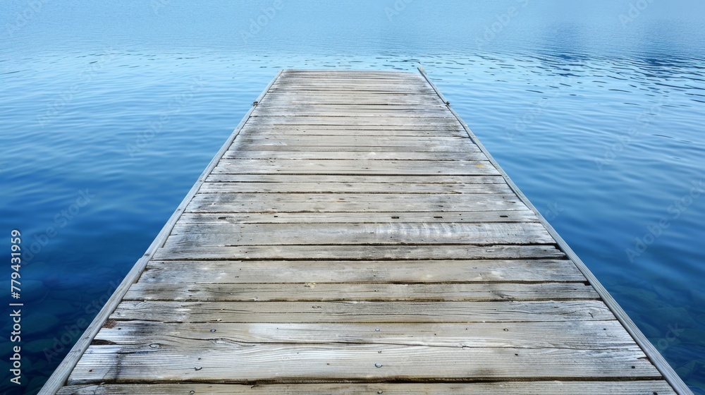 Wooden dock stretching out into a calm harbor with a wooden platform background