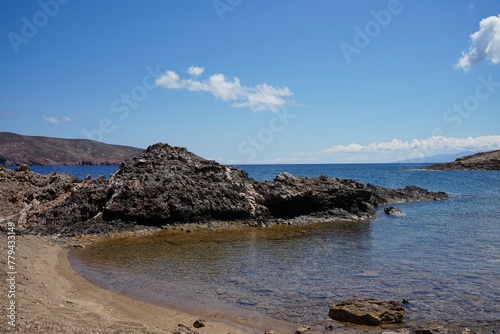 Fototapeta Naklejka Na Ścianę i Meble -  Rocky inlet along the clear waters of a secluded beach in Mykonos, Greece