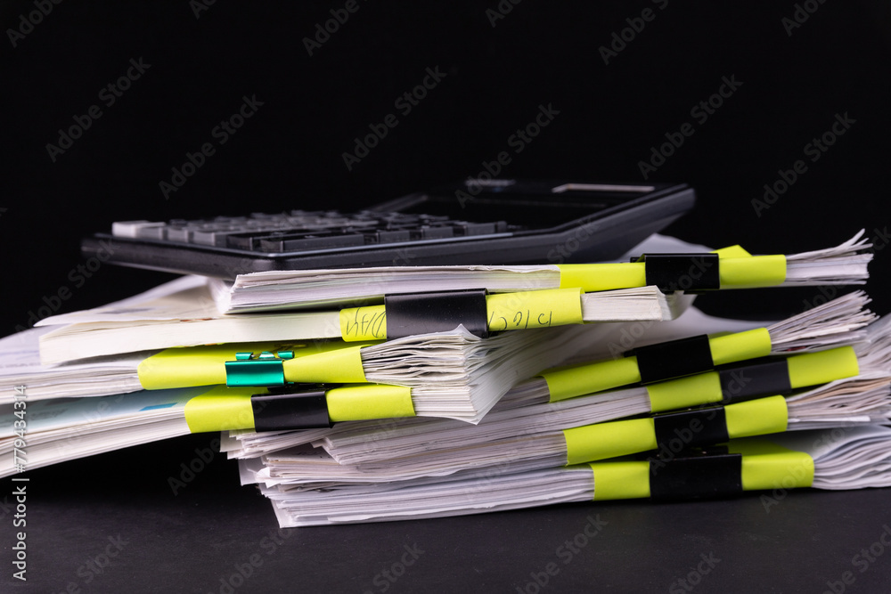 Pile of documents with black clips Clamped stacked on the desk in the office. Pile of documents with black clips Clamped stacked on the desk in the office.