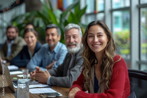 A group of happy people are sitting around a table in a conference room, sharing smiles and leisure time. They are wearing hats and enjoying a real estate event