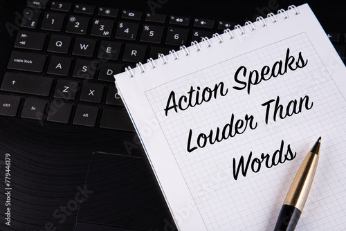 Fotografie Action Speaks Louder Than Words - written on a notebook with a pen