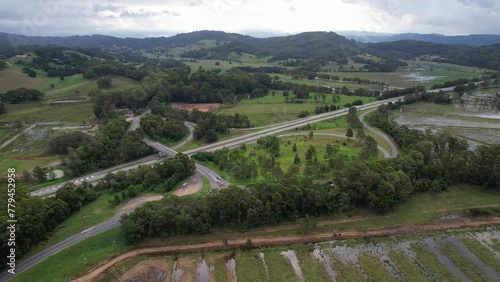 Clothiers Creek Road And Pacific Motorway In Tanglewood, New South Wales, Australia. aerial orbiting shot photo