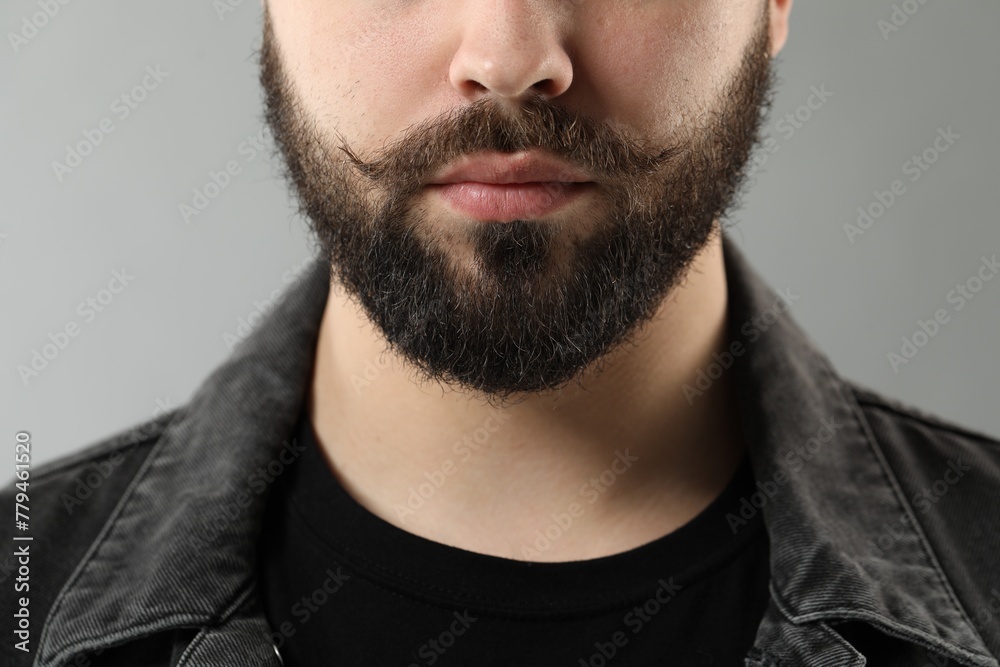 Fototapeta premium Handsome young man with mustache on grey background, closeup