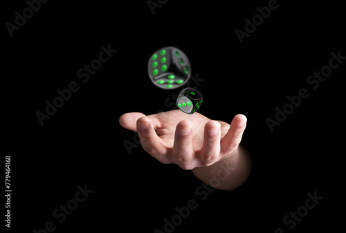 Man throwing dice on black background, closeup