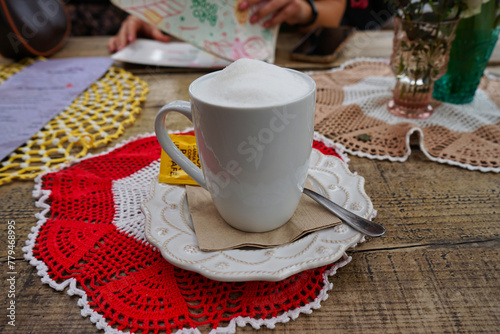 Foamy cappuccino in an artistic outdoor setting at LX Factory in Alcantara, Lisbon, Portugal