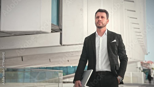 Handsome 30s top manager walking in formal suit. Successful entrepreneur stroll urban city street. Confident serious business man. Young male businessman. 40s employee job. Office work. CEO boss gait.