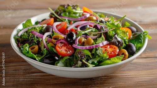 Fresh salad with olives, cherry tomatoes, lettuce and red onion