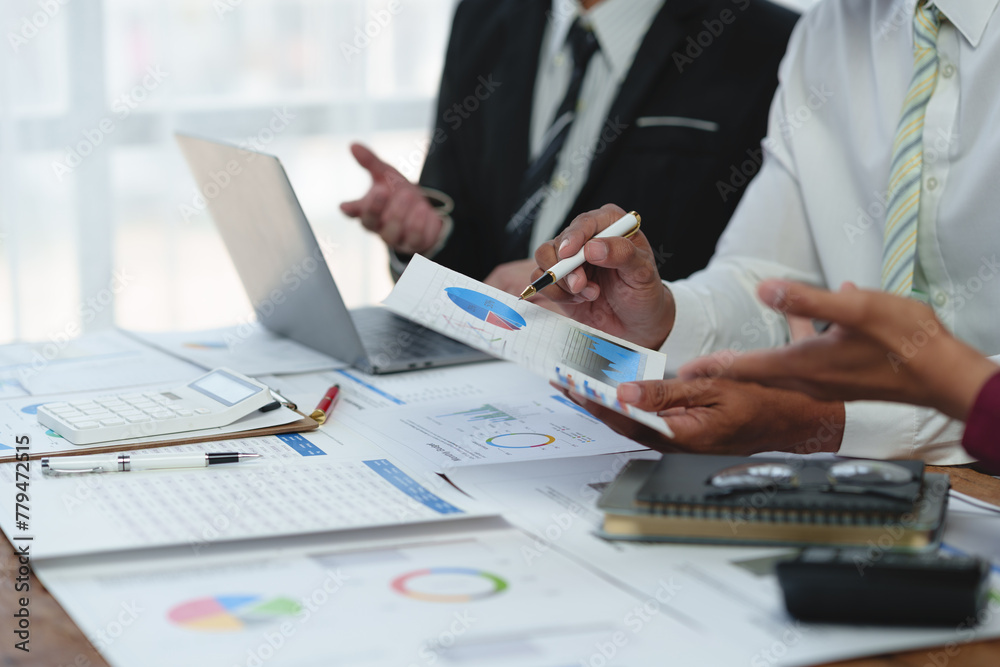 Fototapeta premium Asian business advisor meeting to analyze and discuss the situation on the financial report in the meeting room. brainstorming, discussing, and analyzing business strategy. Financial advisor concept