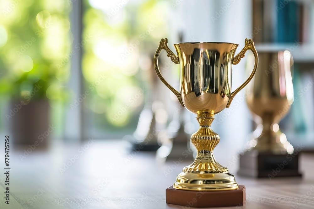 Close-Up of a Shiny Gold Trophy on a Black Base Close-Up of a Shiny Gold Trophy on a Black Base