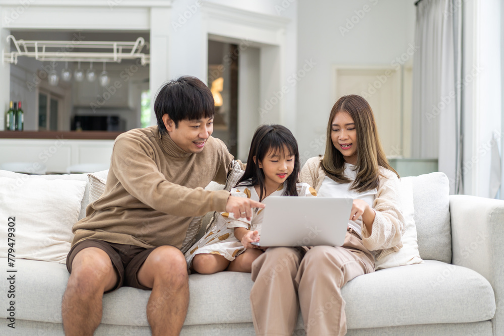 Father and mother with asian kid girl learn on laptop computer reviewing lesson study with online education e-learning.student look for educational knowledge in homeschool at home.Education Father and mother with asian kid girl learn on laptop computer reviewing lesson study with online education e-learning.student look for educational knowledge in homeschool at home.Education