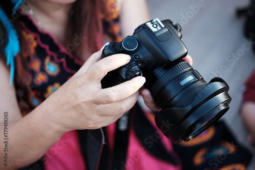 Close up woman hand holding digital camera