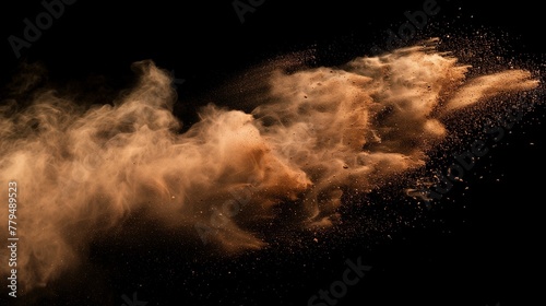 Dramatic dust explosion on a dark backdrop. A dynamic burst of sand and smoke particles captured mid-air, creating a natural yet chaotic effect. photo